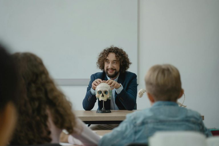 Teacher engaging students with a skull model in an interactive biology lesson.