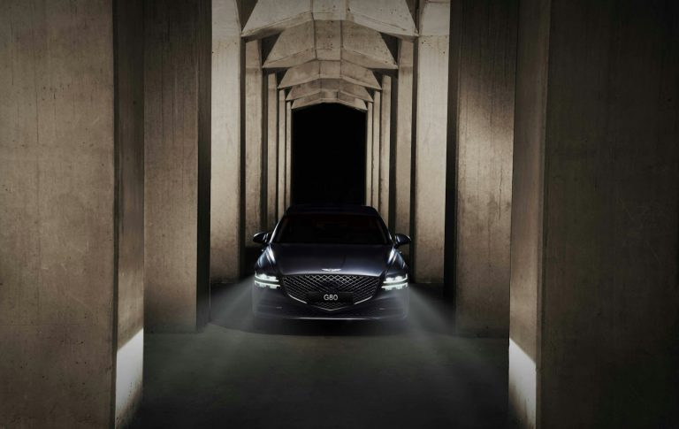 a car is parked in a tunnel of concrete